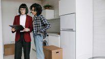 Una joven escucha a la inmobiliaria. También leen el contrato que está por firmar, qué tener en cuenta y costos&nbsp;