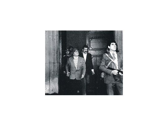 Salvador Allende, tal como se lo retrató en una de sus últimas fotos el día de su muerte: con casco y fusil en mano dispuesto a resistir el golpe pinochetista en La Moneda.