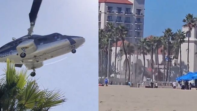 Helicóptero incrustado entre palmeras y edificios en Huntington Beach, tras el accidente que dejó cinco personas hospitalizadas.