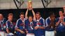 The player holding the World Cup is a reporter and currently practices different sports disciplines. The player holding the World Cup is a reporter and currently practices different sports disciplines.