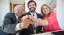 Older adults with their child in the signing of writing that allows them to sell the property and conserve the life usufruct