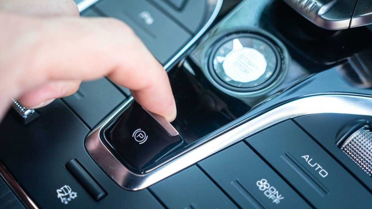 What happens when the electronic hand brake is pressed with the moving car?