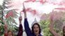In protest, women lit pink smoke flares. In protest, women lit pink smoke flares.