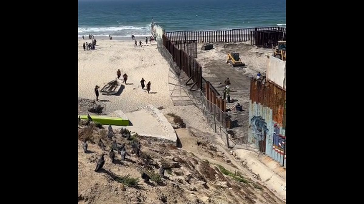 Dozens of migrants cross the wall into the US taking advantage of construction works in Tijuana