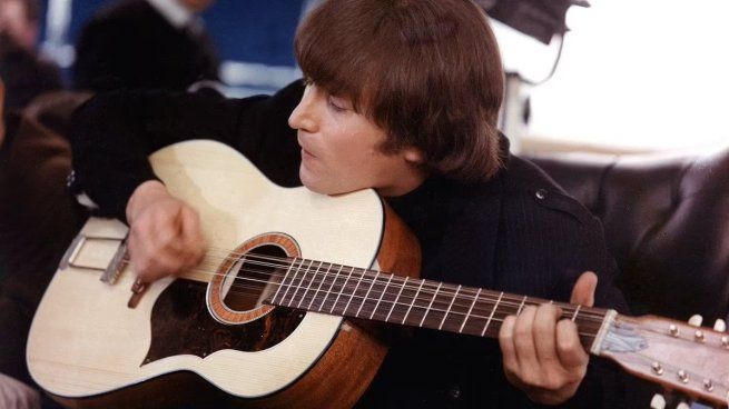 A guitar used by John Lennon and George Harrison in the Beatles was auctioned for a record price