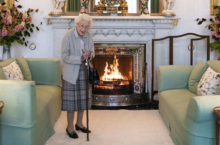 Queen Elizabeth II leaning on a cane in the drawing room of Balmoral Castle in Aberdeen, Scotland. Queen Elizabeth II leaning on a cane in the drawing room of Balmoral Castle in Aberdeen, Scotland.