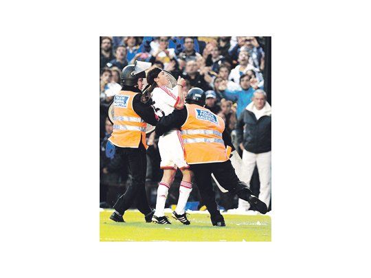 Matías Almeyda forcejea con los policías mientras provoca a los hinchas de Boca besando la camiseta. Por eso le iniciarán un juicio contravencional.