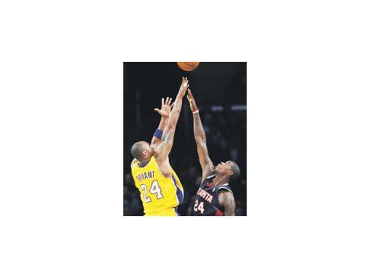 Kobe Bryant se eleva más alto que Marvin Williams en la victoria del líder, Lakers.