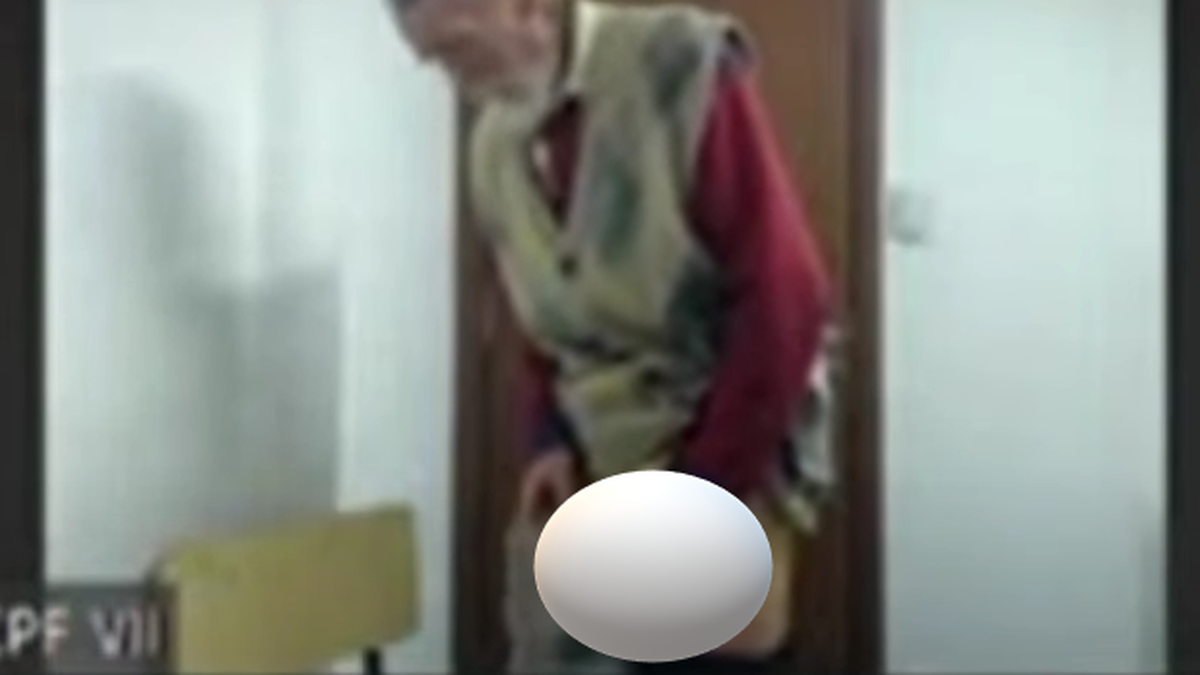 A repressor stripped naked during a trial for crimes against humanity