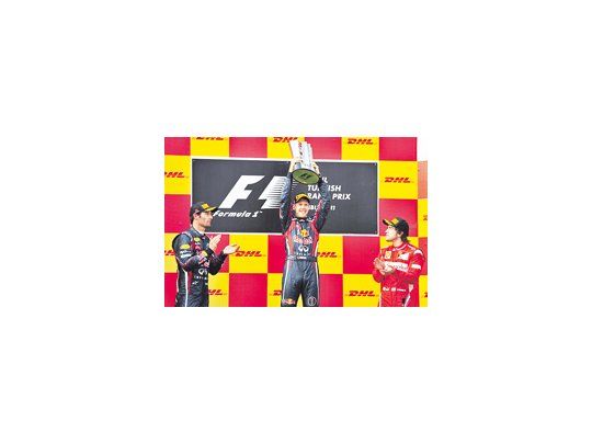 Mark Webber y Fernando Alonso aplauden a Sebastian Vettel. El alemán ganó el GP de Turquía y lidera con comodidad el campeonato mundial de F-1.