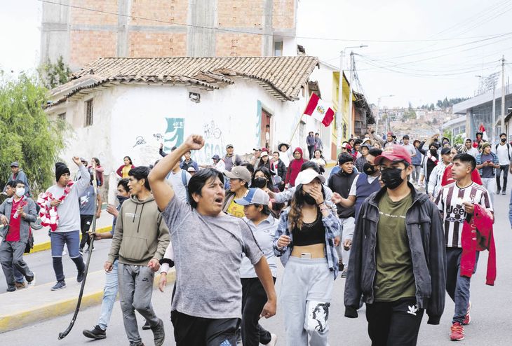 ALCANCE. Manifestantes caminan por Cuzco, la principal ciudad turística de Perú. Testigos reportaron que cientos de viajeros quedaron varados allí a raíz de la crisis política.