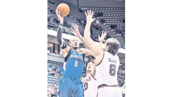 Carlos Delfino y Andrew Bogut intentan tapar a Michael Beasley, de los Timberwolves. El argentino cumplió una gran labor en el triunfo de los Bucks.