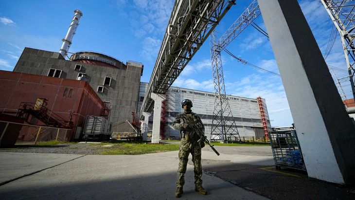 A Russian soldier guards the entrance to the Zaporizhia nuclear plant in southern Ukraine.