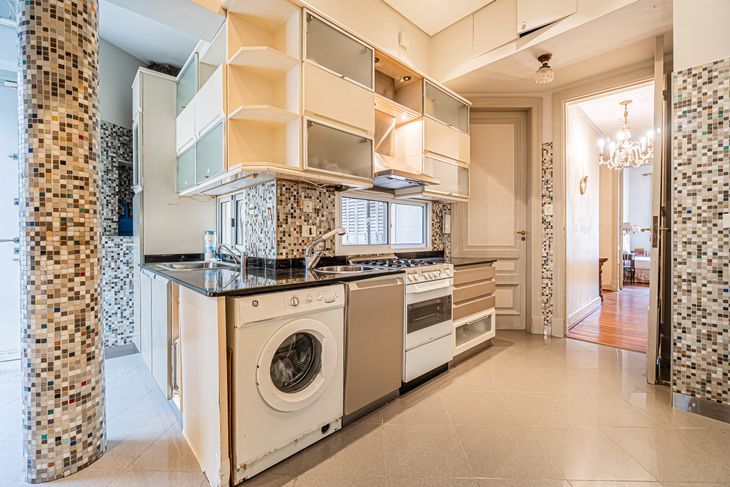 La cocina fue modernizada con mobiliario contemporáneo, sin alterar la distribución general del departamento La cocina fue modernizada con mobiliario contemporáneo, sin alterar la distribución general del departamento