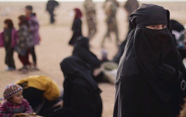 GUERRAS INSOSTENIBLES. Una joven observa a la cámara en Bahhouz, Siria, donde fuerzas kurdo-árabes disputan la última batalla contra el Estado Islámico (EI). Donald Trump afirma que la batalla contra el yihadismo está a un solo paso, aunque es desmentido por sus propios asesores.