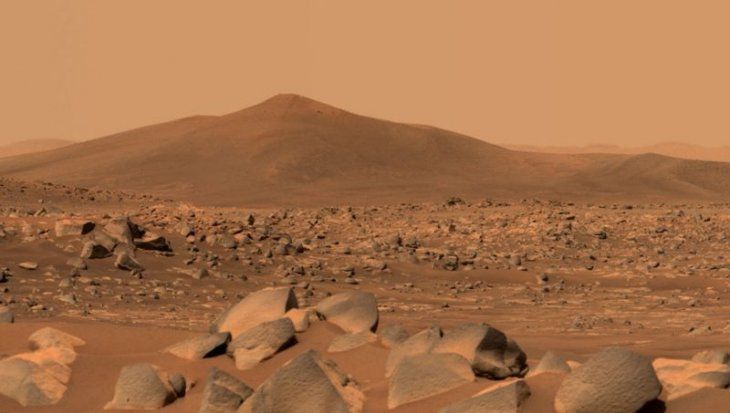 This image shows Santa Cruz, a hill located 2.5 km from the rover.  The whole scene inside Jezero crater on Mars.  The edge of the crater can be seen on the horizon line behind the hill.