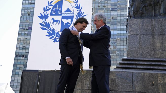 Tabaré Vázquez coloca la banda presidencial a Luis Lacalle Pou.