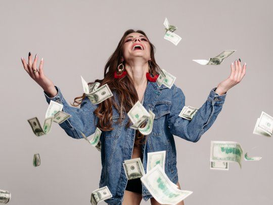 happy-laughing-girl-in-denim-jacket-with-flying-banknotes-around.jpg