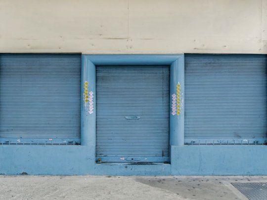 de zuviría. Las fachadas de los comercios con las persianas cerradas brindan un testimonio silencioso del mundo clausurado y opresivo, al que ni siquiera los graffitis logran infundir vida. 