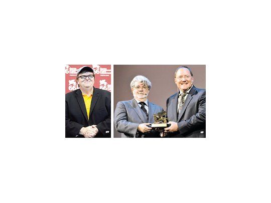 Michael Moore (izq.) presentó «Capitalism: A Love Story». George Lucas, director de «Star Wars», entregó ayer el León de Oro a la trayectoria a John Lasseter, creador de Pixar («Toy Story», «Wall E», etc.).