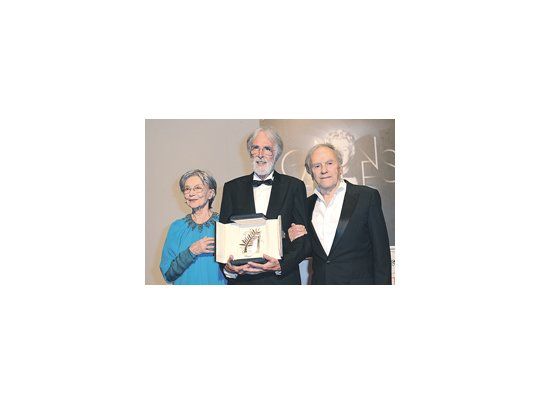 Emmanuele Riva y Jean-Louis Trintignant a ambos lados de Michael Haneke, después de la Palma de Oro por «Amour».