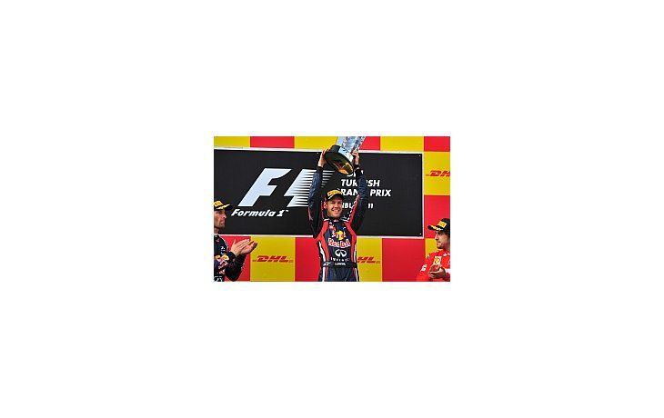 Sebastian Vettel levanta el trofeo en Turquía. Mark Webber y Fernando Alonso lo miran y aplauden.