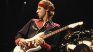 Mark Knopfler and one of his auctioned guitars. Mark Knopfler and one of his auctioned guitars.