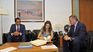 Karina Rando signing her signature under the gaze of the Secretary of the Presidency, Álvaro Delgado, and the Undersecretary of the Ministry of Public Health, José Luis Satdjian.