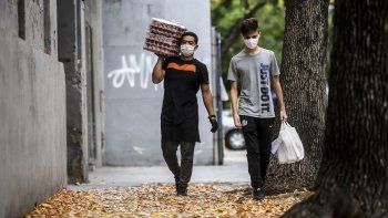 Dos trabajadores caminan las calles de Buenos Aires durante la pandemia del coronavirus.