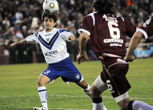 Papa disputa la pelota. El 1 a 1 con Lanús fue muy trabado, pero sirvió para llegar vivo a la última fecha.