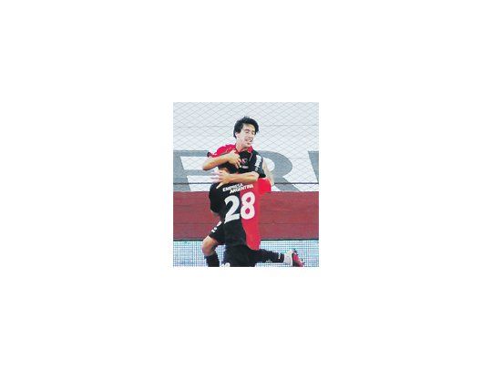 Martín Tonso se le cuelga del cuello a Pablo Pérez, autor del segundo gol. Newell’s no pudo sostener la victoria y cosechó el 13° empate en el certamen.