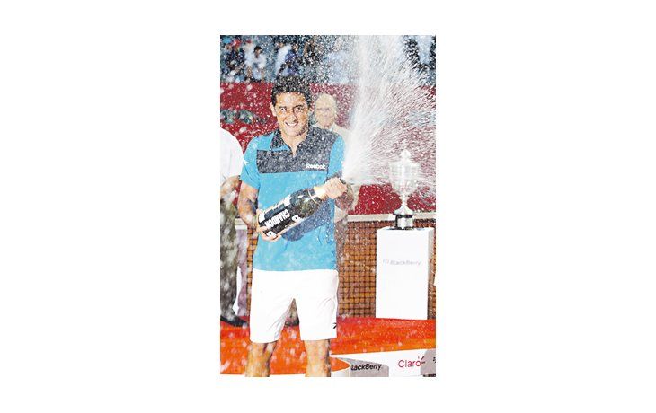 Nicolás Almagro festeja con champán tras obtener el ATP de Buenos Aires. Esta fue la tercera final consecutiva ganada por un español.