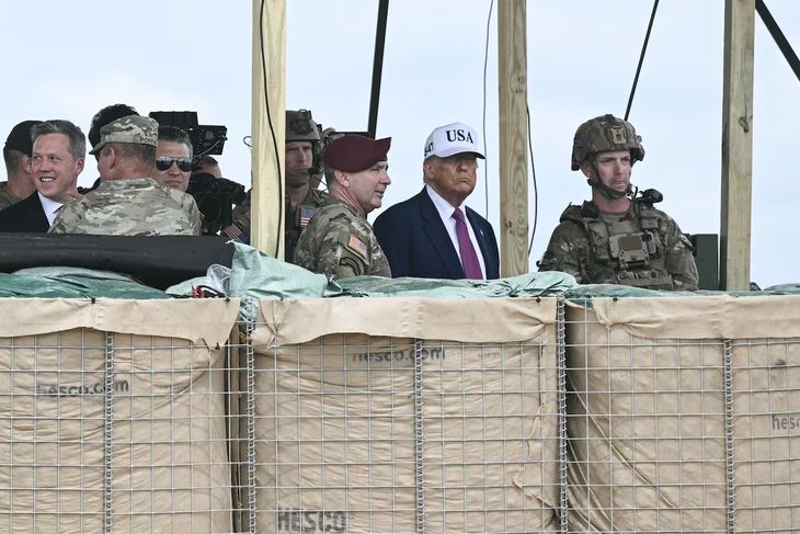 President Donald Trump surrounded by military. President Donald Trump surrounded by military.