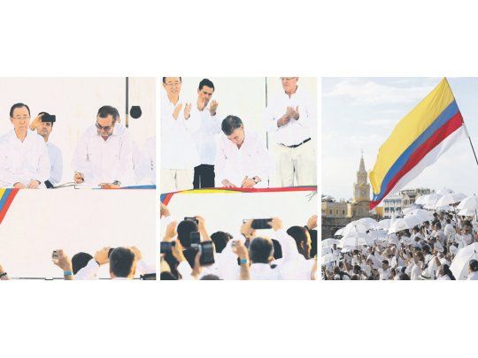 Compromiso. Juan Manuel Santos y Rodrigo Londoño, presidente de Colombia y líder de las FARC, firmaron ayer en Cartagena el tratado de paz que pone fin al último conflicto armado del hemisferio occidental. La bandera flameó con el simbólico agregado de una franja blanca.