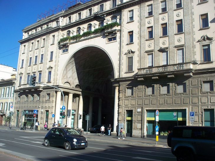 Otra imagen del frente del edificio ubicado en Milán. Ambos edificios comparten forma en “U”, arco central jerarquizado y ornamentación geométrica clásica