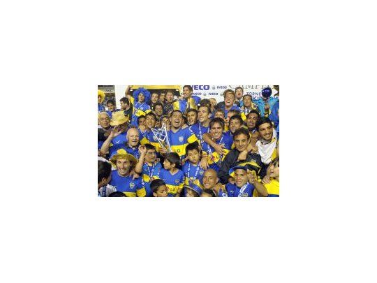 Campeón. Boca y el momento más deseado: junto a la trofeo y festejando en el podio.