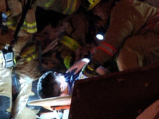 Los bomberos sacaron en camilla al nene hallado entre los escombros en el derrumbe en Miami.