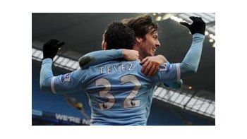 Silva abraza a Tevez en su 50° gol con la camiseta de Manchester City.
