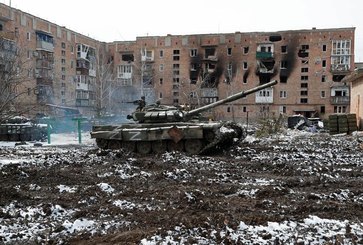 A tank with the letter "Z" painted on it is seen in front of a residential building that was damaged during the conflict between Ukraine and Russia in the separatist-controlled town of Volnovaja in Donetsk region, Ukraine.