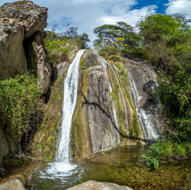 A waterfall that flows into a river is one of the main attractions of this town in Catamarca A waterfall that flows into a river is one of the main attractions of this town in Catamarca