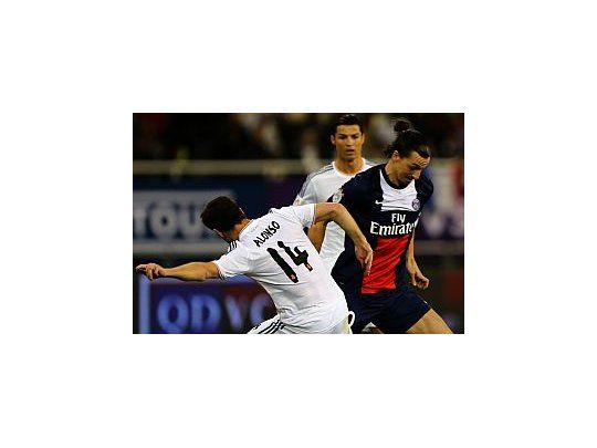 Ibrahimovic disputa la pelota con Xavi Alonso. Detrás, Ronaldo.