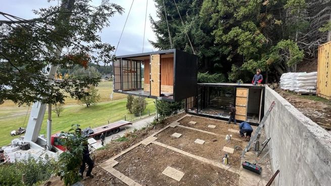 Montaje de módulos industrializados en un terreno en pendiente, con grúa y bases preparadas para el armado de la vivienda